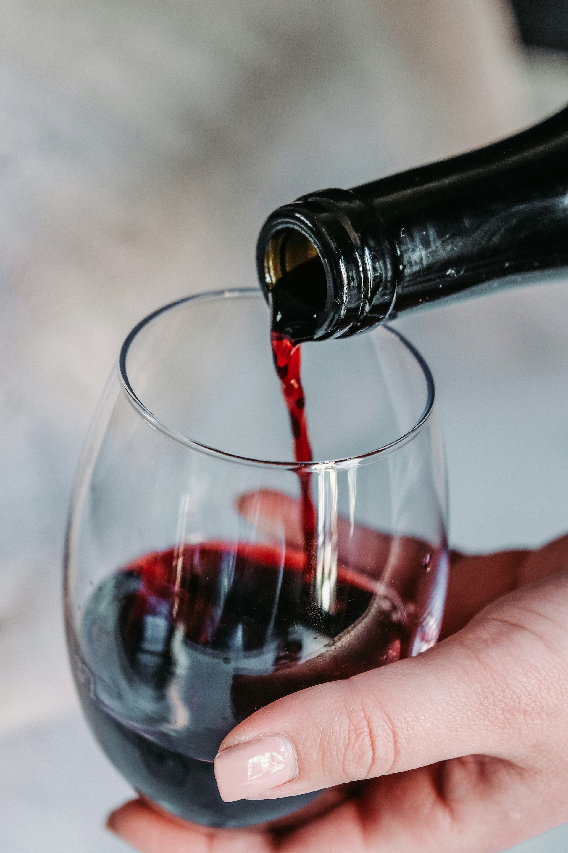 Sommelier pouring a glass of red wine at a private tasting
